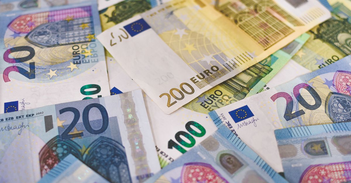 Close-up of various Euro banknotes scattered on a surface, highlighting European currency.